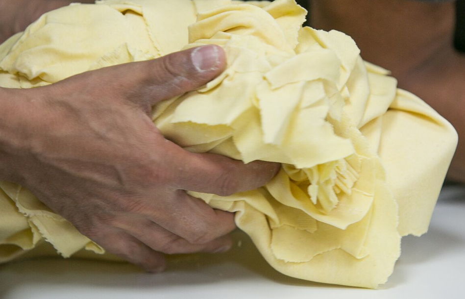 Rolling pasta by hand.