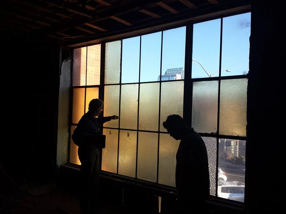 photo: Preservation Sacramento- The two windows with tape on them are new windows, test samples installed to compare with the old windows to see which worked best as a replacement for lost panes in the depot's windows.