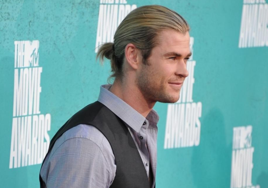  “Thor” star Chris Hemsworth takes heroic measures to keep his long hair tidy.