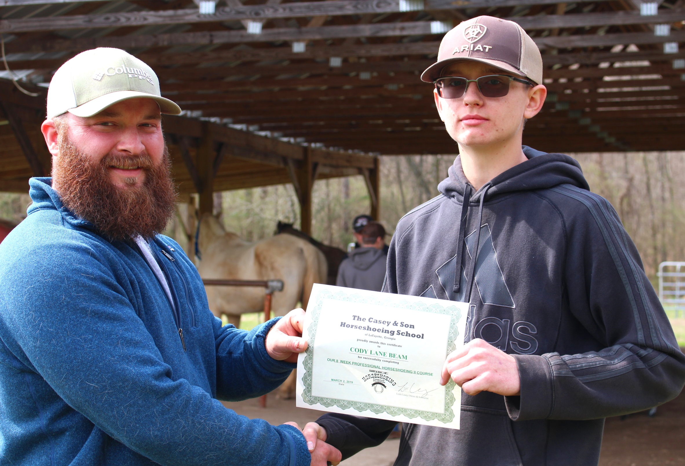 Instructor & Owner Link Casey with Graduate Cody Beam