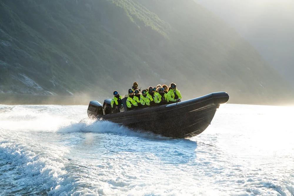 RIB boat cruising across the fjord