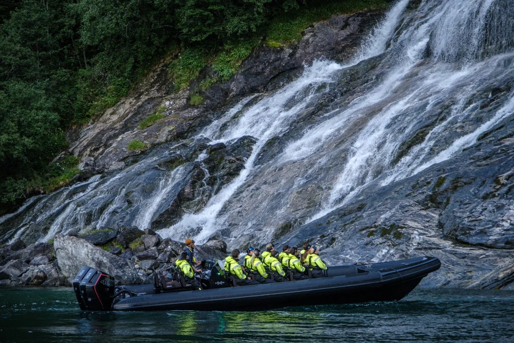RIB boat near a spectacular waterfall