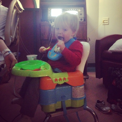Improvise : My son loves a routine. My wife is stuck in bed but usually feeds him dinner. So you take the travel highchair and stick him beside!