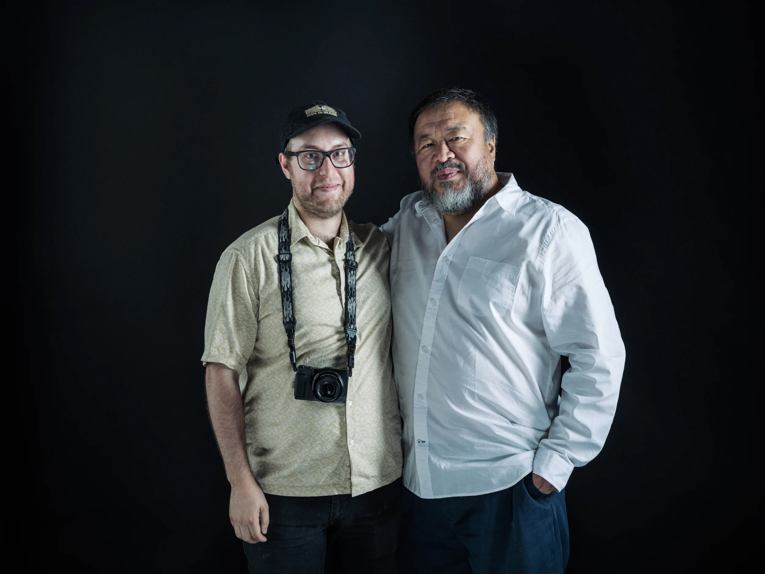 Portrait of Travis Mitzel (left) with artist Ai WeiWei. Photo by Chad Batka.