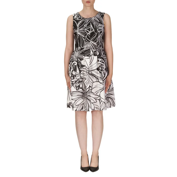 The intricate design of this floral Joseph Ribkoff dress provides a stark contrast against the top and attracts the eye downward, towards the white highlight. The full skirt balances any top heaviness and alludes to a proportional frame. 