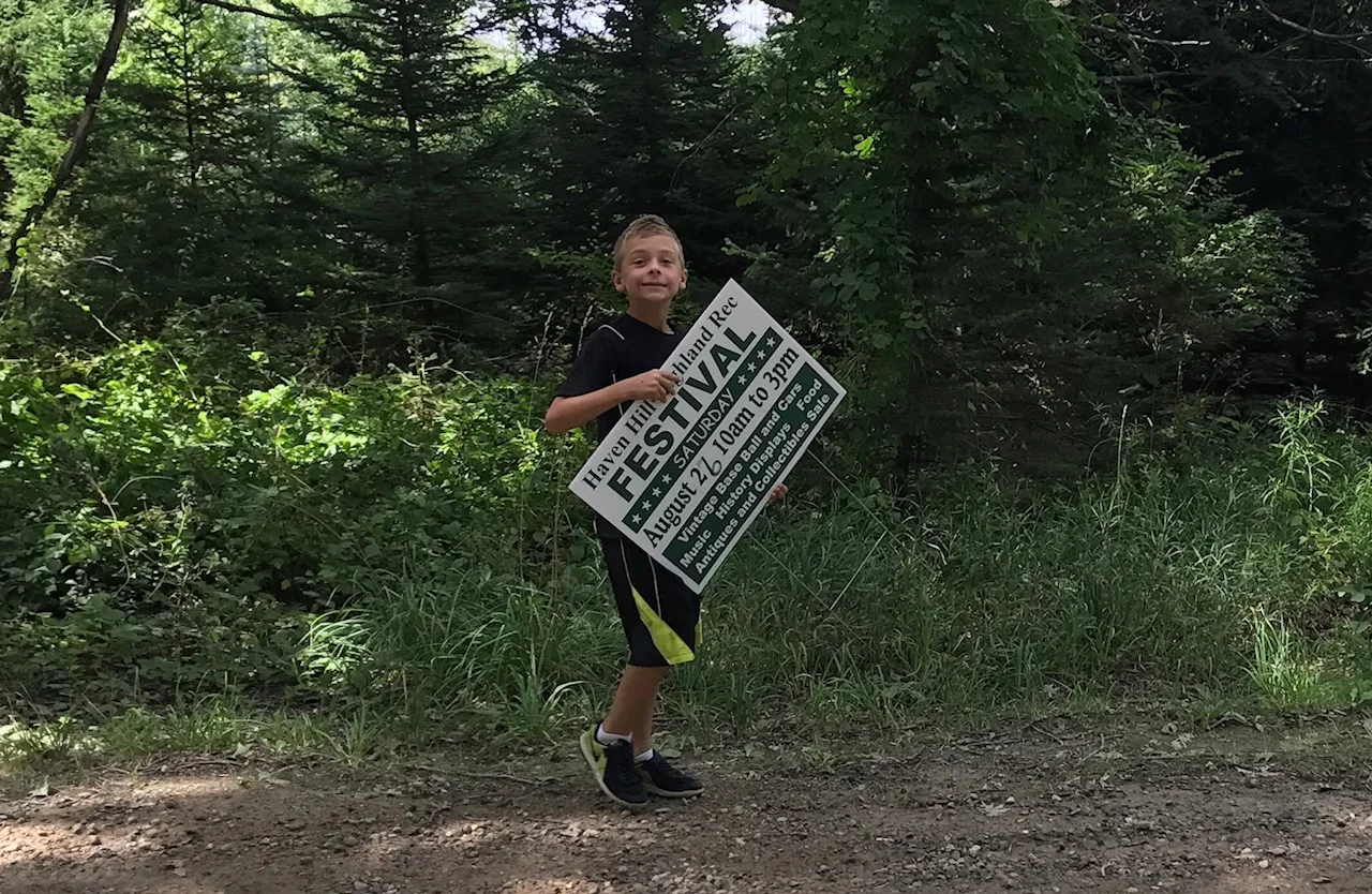 Above: The authors's son Jack Fitzgerald helping to put out this year's Haven Hill Festival signs at Highland State Recreation Area. 