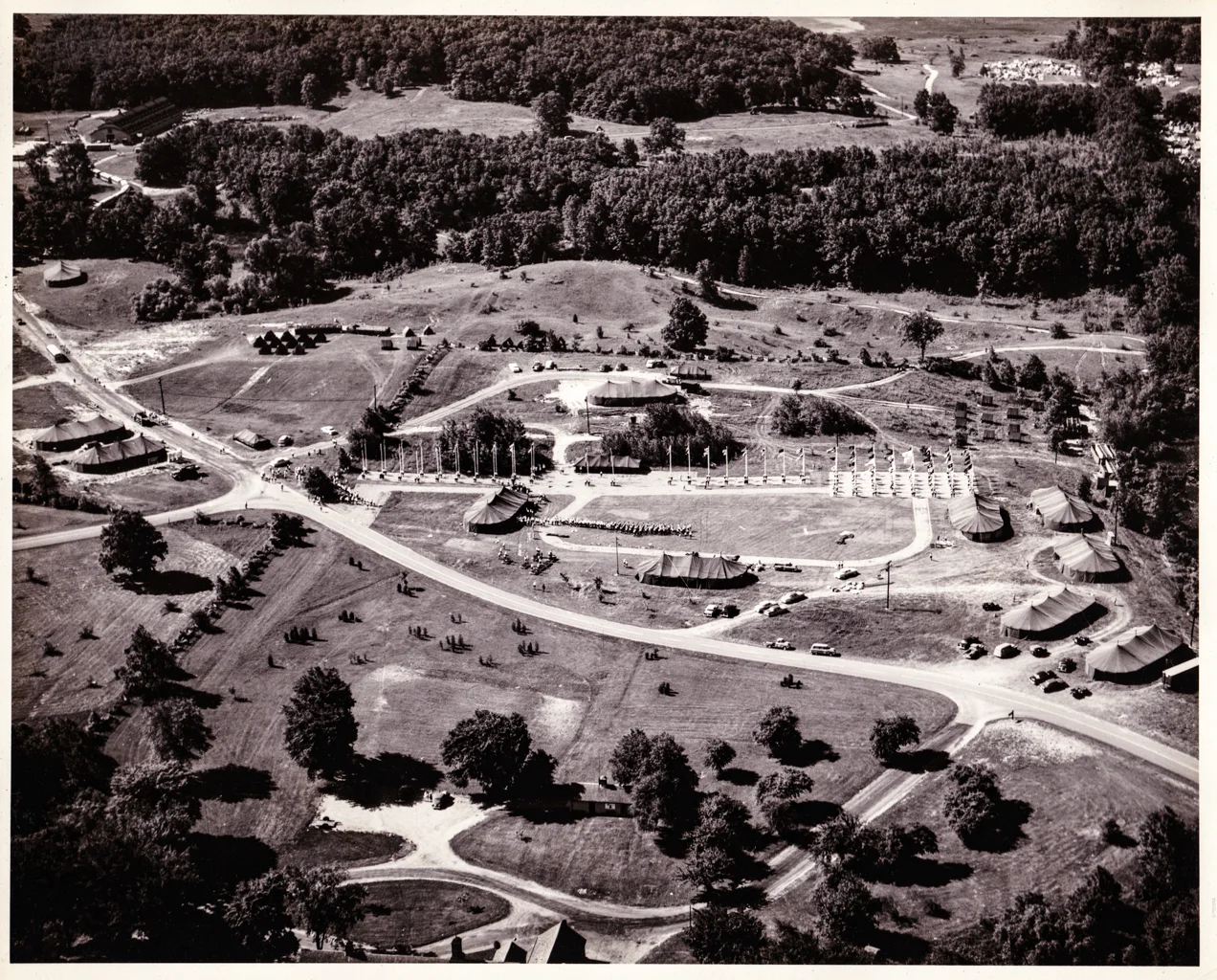 ABOVE: An amazing aerial photograph of the 1956 Girl Scout Senior Roundup in Highland State Recreation Area. This giant daily Flag Ceremony was held in front of what its now the park's maintenance buildings complex. Photo Property FOHRA.