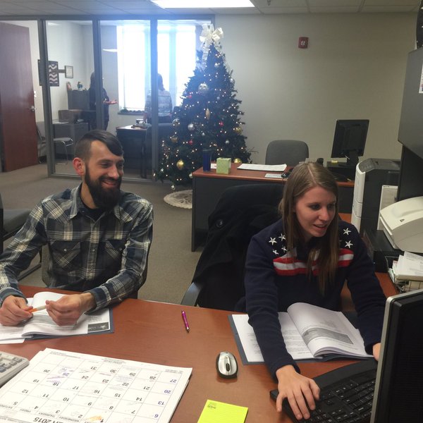 Kurt teaches Jessica about Google spreadsheets at her desk in Laclede County, Missouri