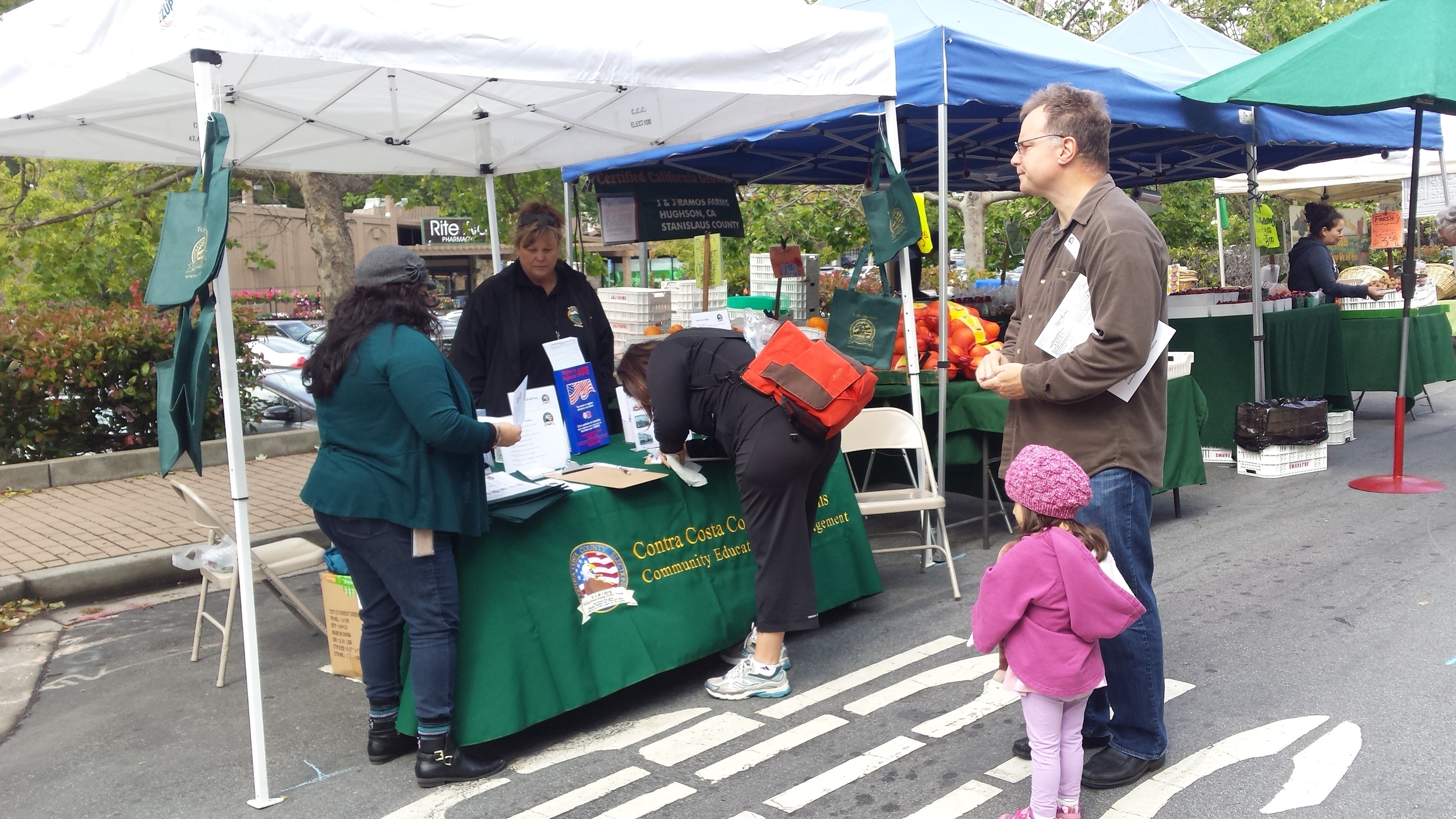 Staff members of Contra Costa's Civic Engagement and Education program register voters at a local farmers' market. Photo courtesy of Paul Burgarino and Contra Costa County.