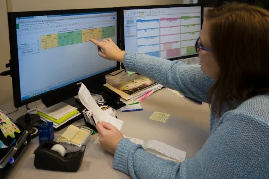 Jessica Lara shows off her office's spreadsheet. Photo by Micah Cutler.