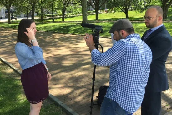 Kevin Issa and Jason Hernandez film intern Kathryn Dery for one of the RI Votes videos. Photo by Joe Graziano.