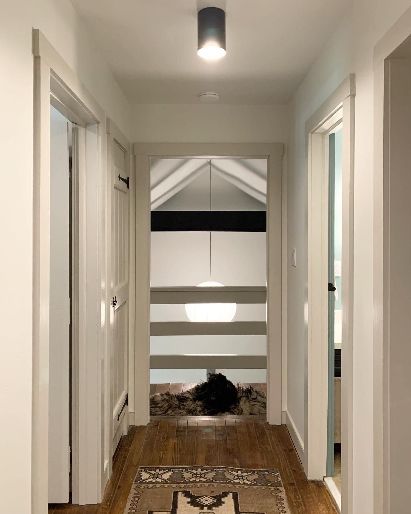 From dark to light. Another before and after with a view of the mezzanine overlooking the living room. I kept all of the original door hardware but nixed the dated, dust collecting bi-fold doors. I salvaged some of the old cabin doors that closed off
