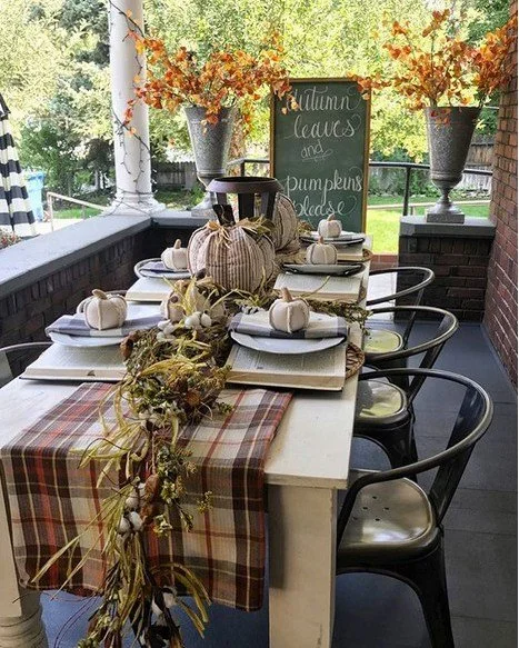 #ThrowbackThursday &mdash; can you believe how bare our front porch used to be? We have really grown these past few years! We still love looking back at this cozy fall setup filled with pumpkins, plaid, and vintage touches. 🍂

Old books as chargers,