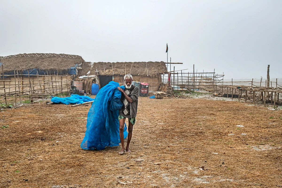 Man in Dublar Char Carrying a Fishing Net