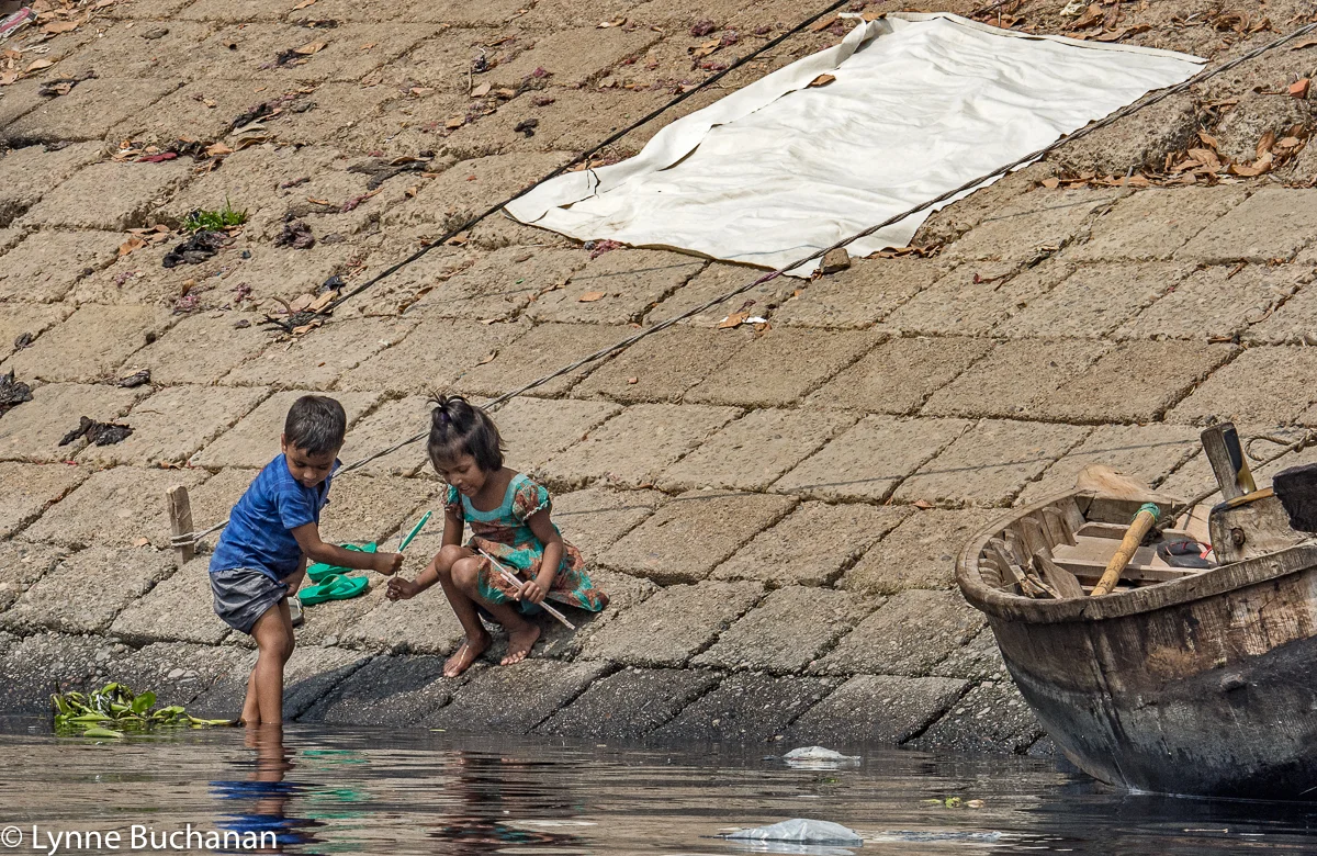 Children Looking at Something in the River