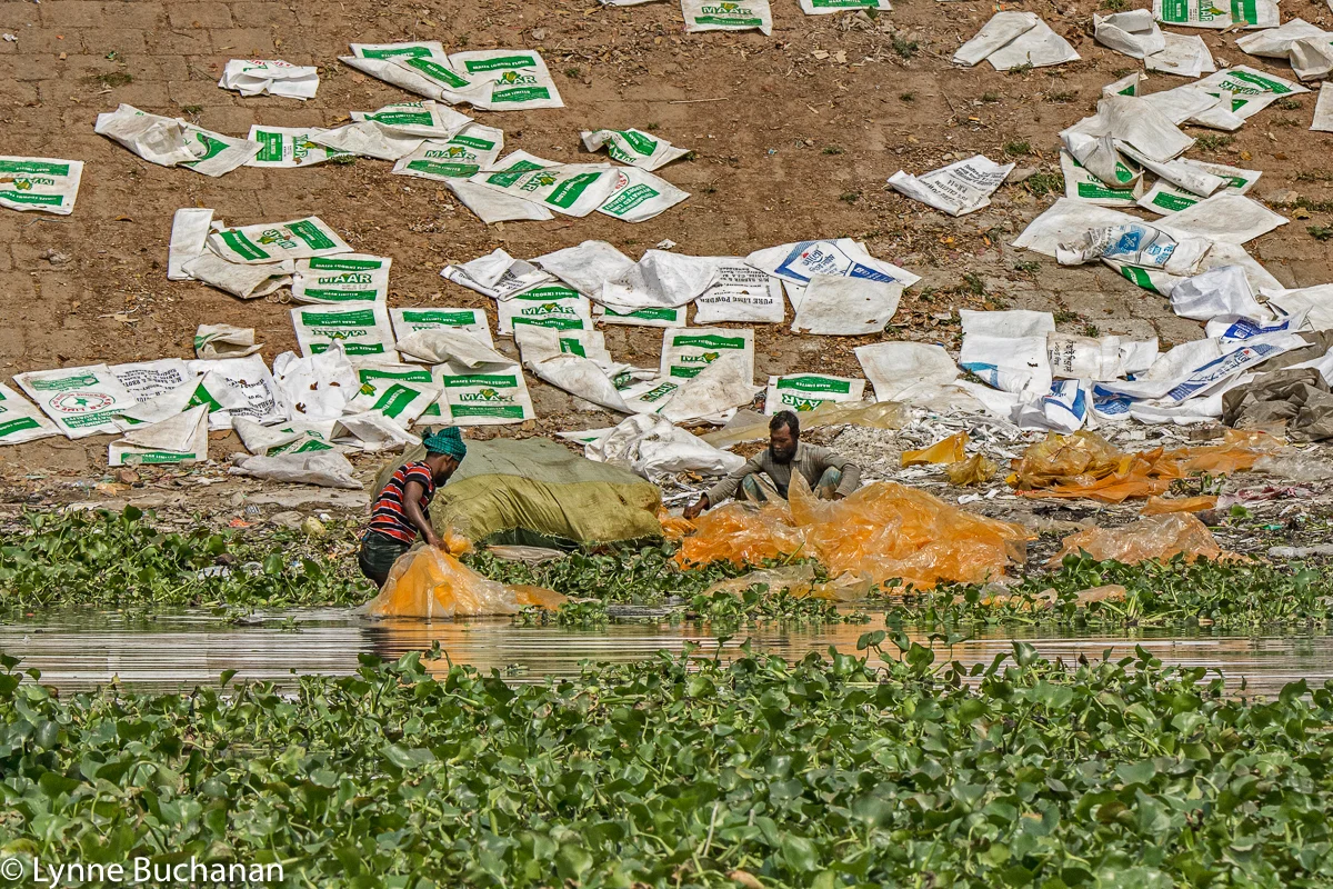 Men Rinsing Chemically Tainted Plastic Bags along the Buriganga River