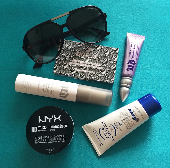 Clockwise From The Top: (1) Boscia Black Charcoal Blotting Linens, (2) Urban Decay Eyeshadow Primer Potion In 'Original', (3) Rimmel London Fix & Perfect Primer, (4) NYX Studio Finishing Powder, and (5) Urban Decay De-Slick Oil Control Makeup Setting Spray