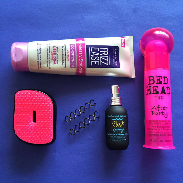 From Left To Right: 1) John Frieda Flawlessly Straight Conditioner, 2) Tangle Teezer, 3) Goody Simple Styles Spin Pin, 4) Bumble and bumble Surf Spray, and 5) Bed Head After Party Smoothing Cream