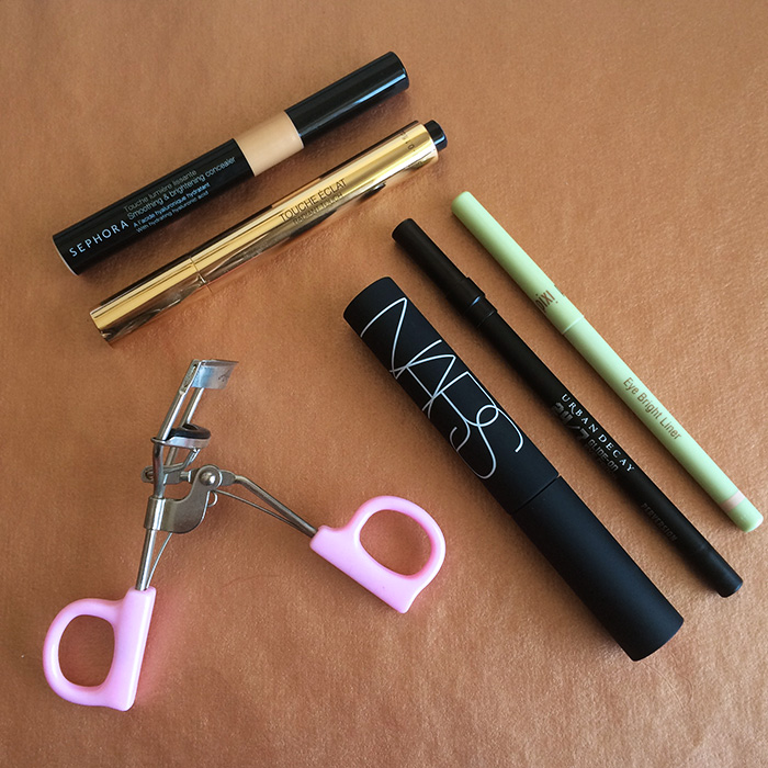 From Top To Bottom: 1) Sephora Smoothing & Brightening Concealer, 2) Yves Saint Laurent Touche Eclat, 3) NARS Audacious Mascara, 4) Urban Decay 24/7 Glide-On Eye Pencil In 'Perversion', 5) Pixi Eye Bright Liner