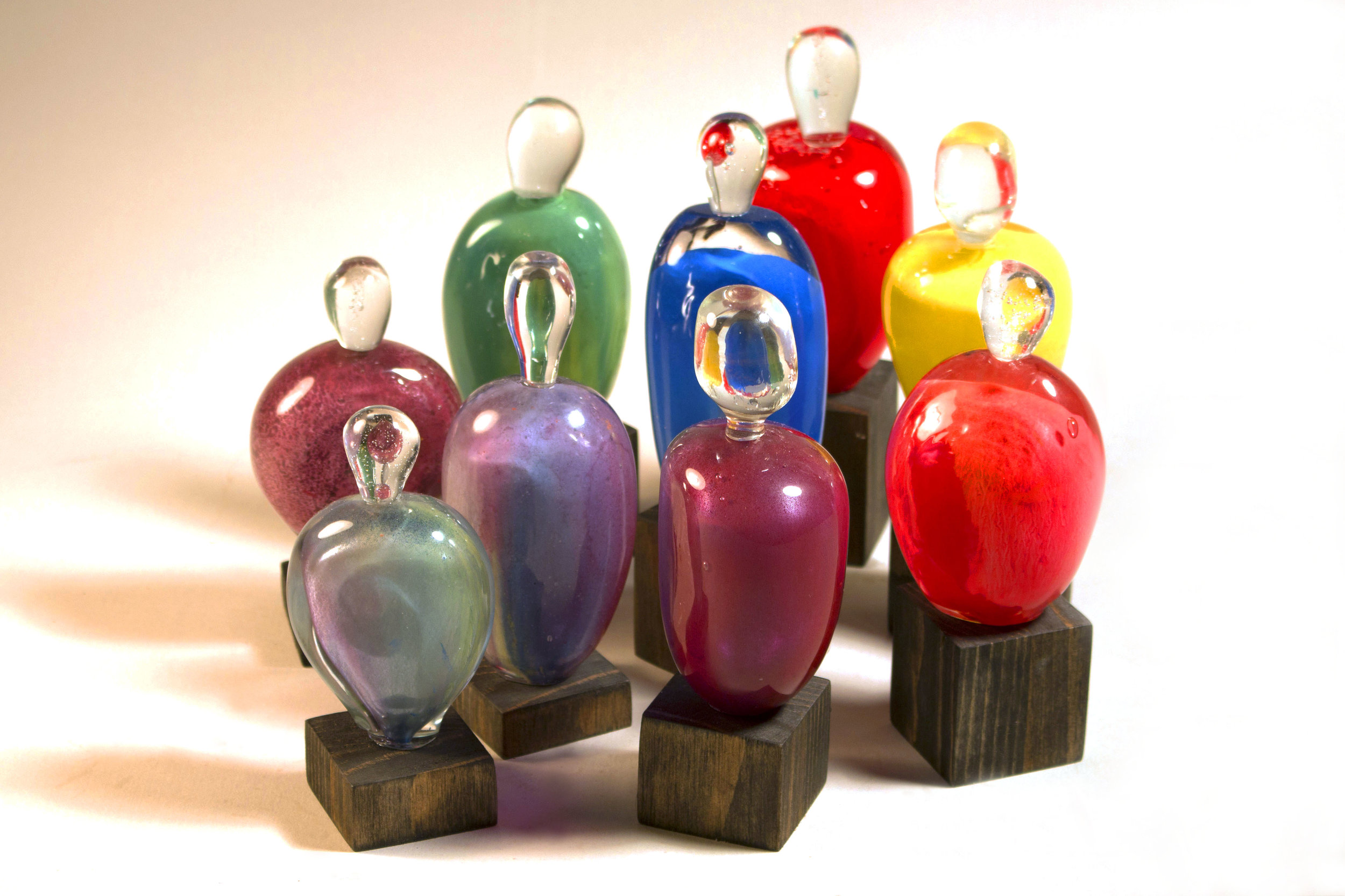 kyle lacey in another work, kyle wanted to make a sculpture about the community he finds himself in. after many conversations he came to the idea of these bottle forms, but rather than the cliche'd 'rainbow' of colors he chose to use a MIXTURE of colors in each of the figures to show that gay men are more than just that one thing. note: we do not teach color glass application in glass i. students are shown a variety of alternative color applications (paint, ink, marker etc) to use. in this way STUDENTS learn to find creative ways to express their ideas without being limited by their skill level.