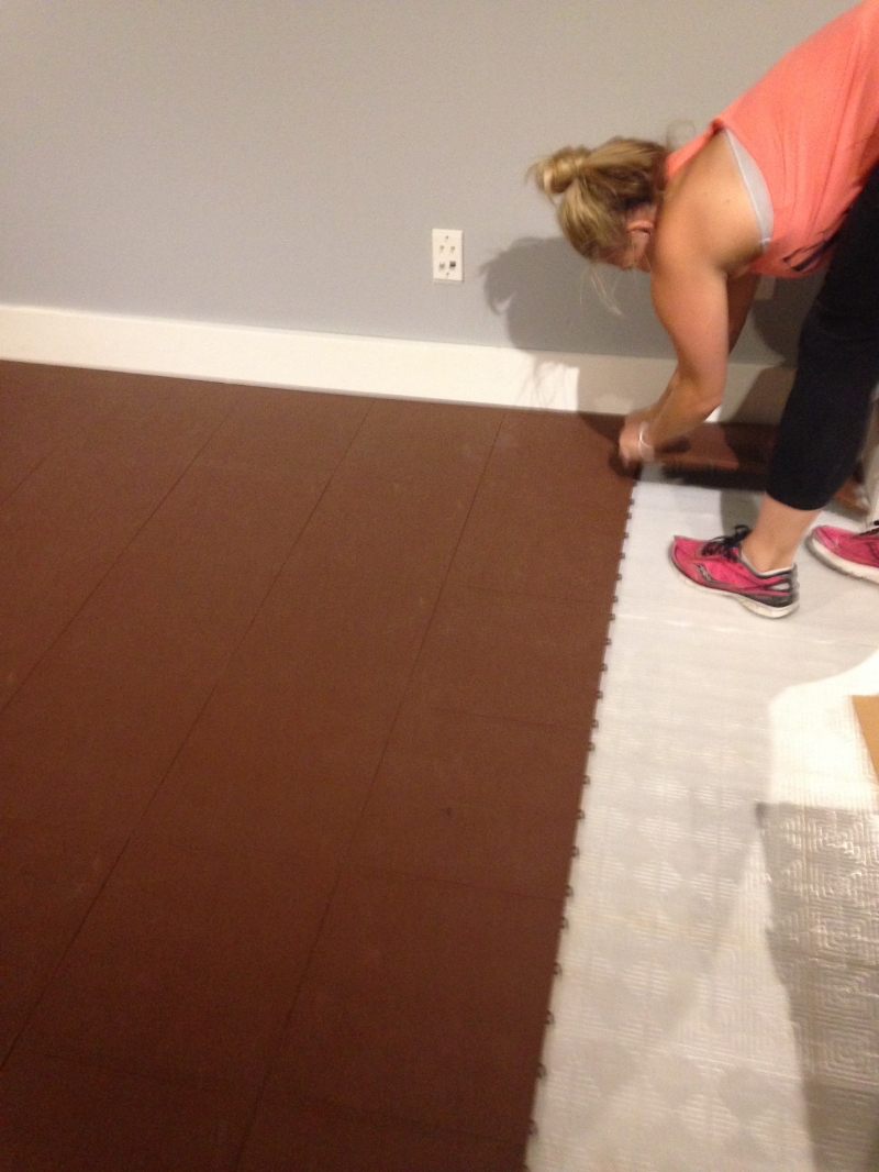 Kate ripping up the ugly brown flooring.