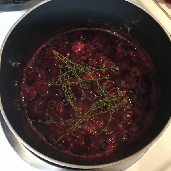 Here are the cranberries, water & sugar doing their thing. I added the thyme for a short time because I didn't want the thyme to overwhelm the flavor. Say that 5 times fast. 