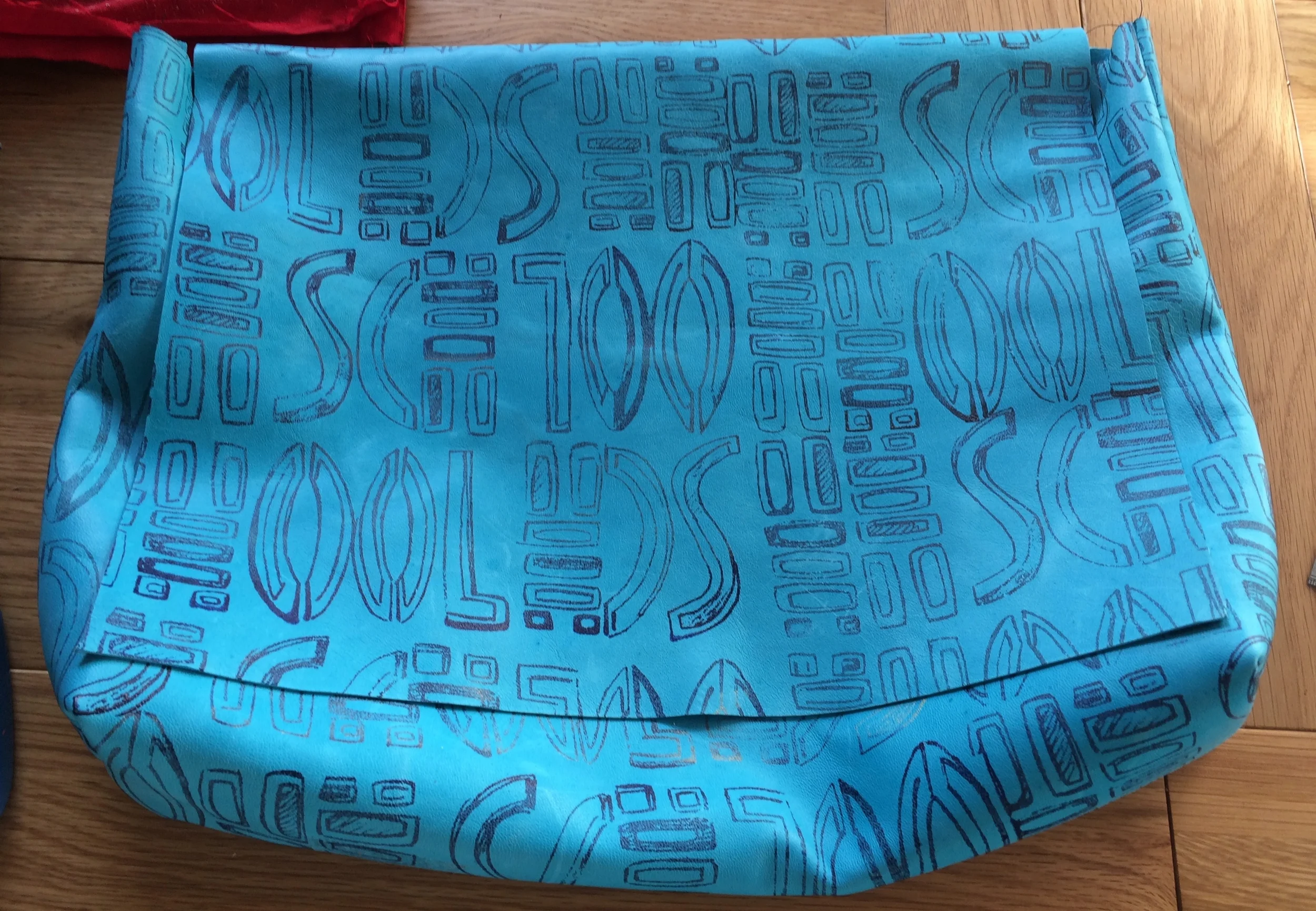 Hand printed turquoise leather clutch bag