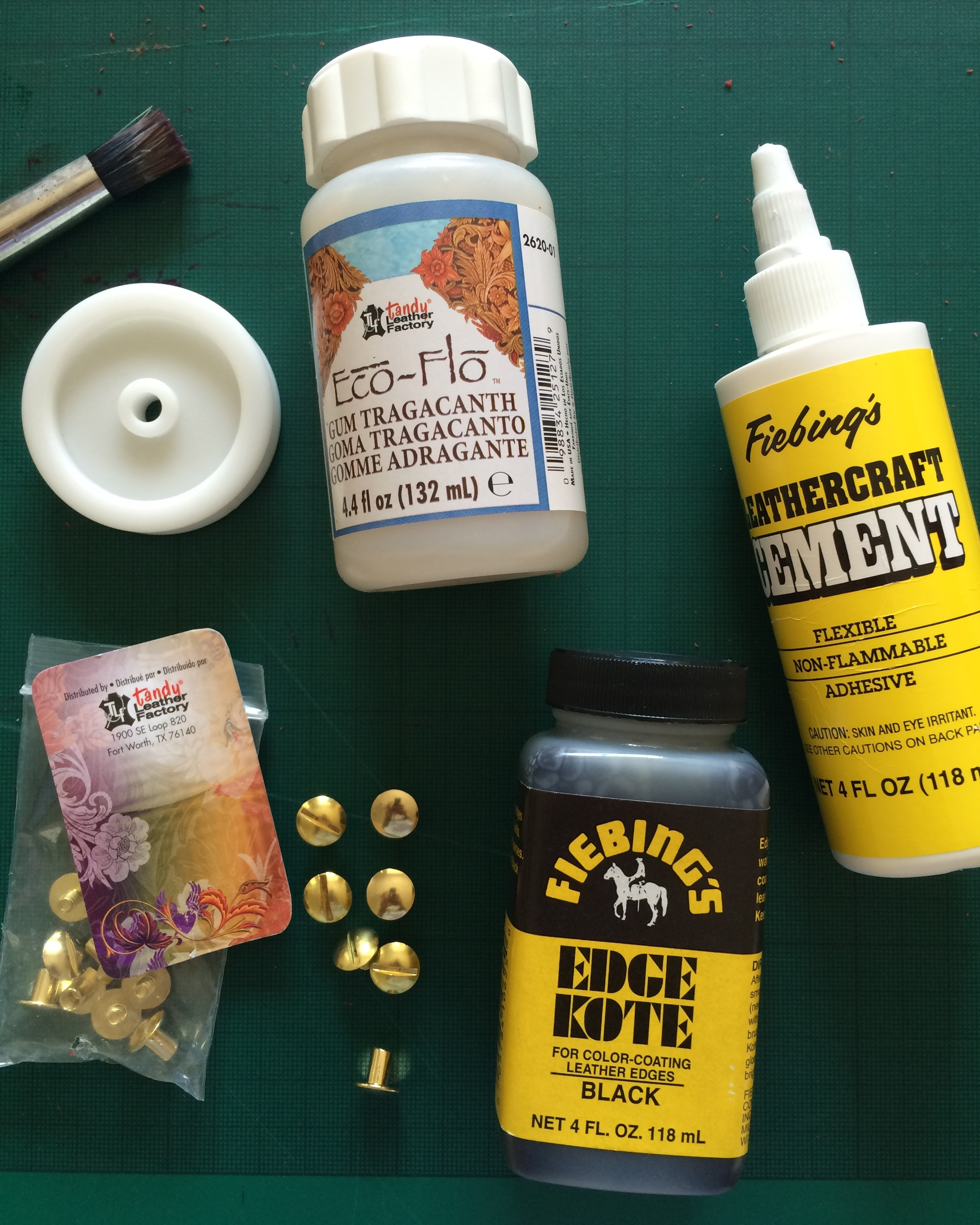Clockwise from left to right: the edge slicker; used in conjunction with the Gum Tragacanth to burnish and neaten the raw edges; Fiebing's leathercraft cement (i.e. leather glue!); Edge Kote to paint the raw edges; and finally the brass screw rivets (or Chicago screws as the website calls them).