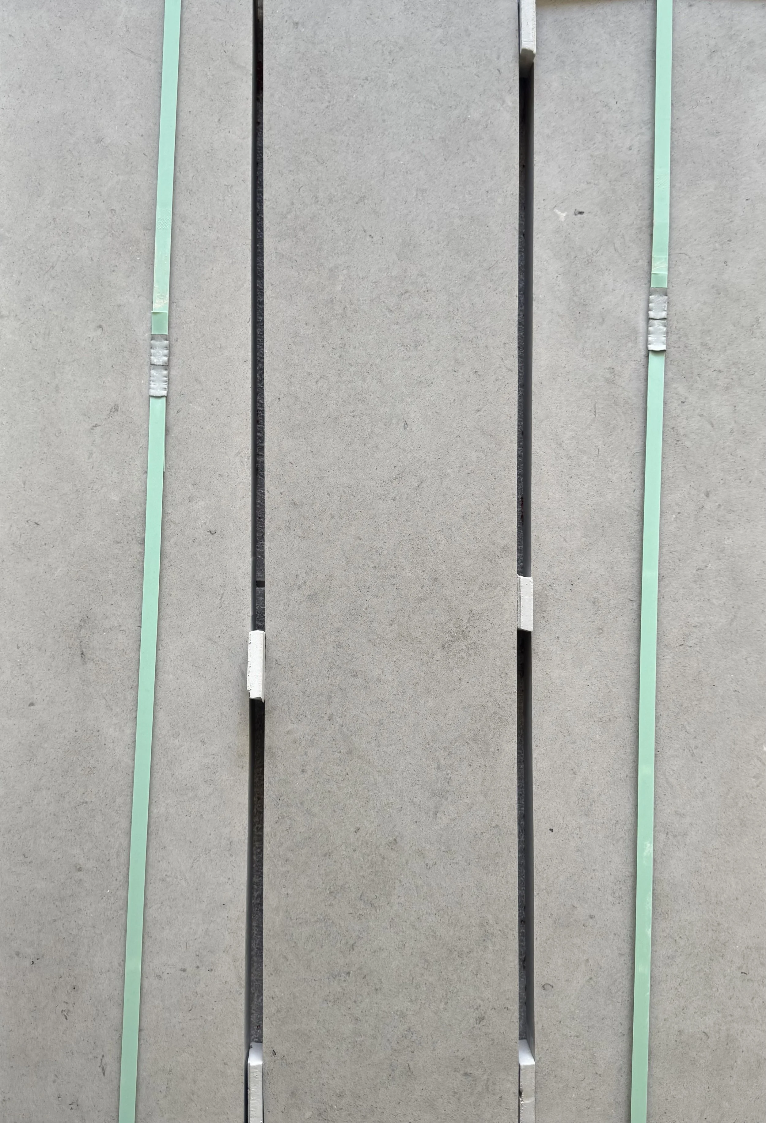 Close-up view of a modern concrete bench with metal and glass details.