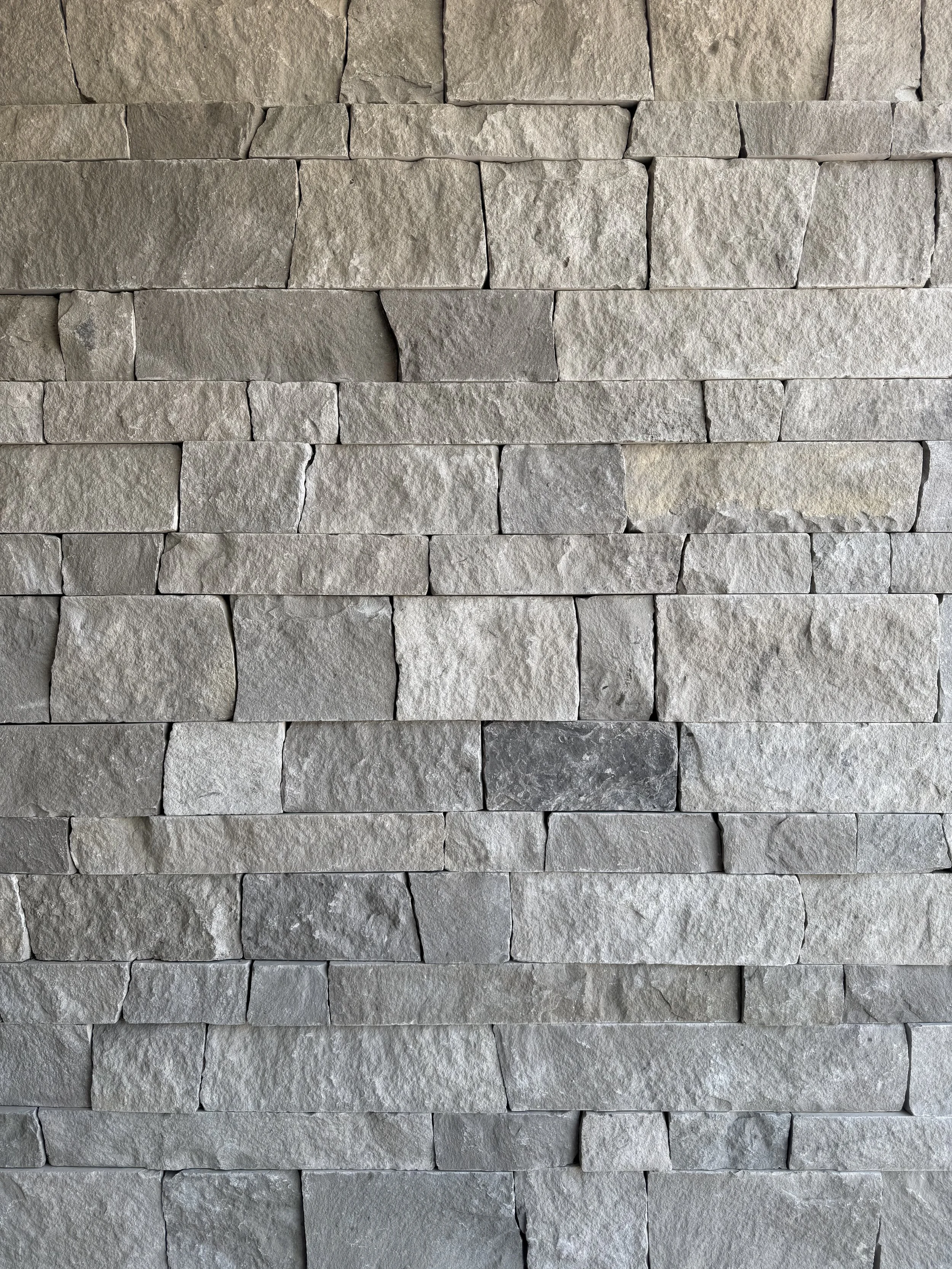 A close-up view of a gray stone brick wall.