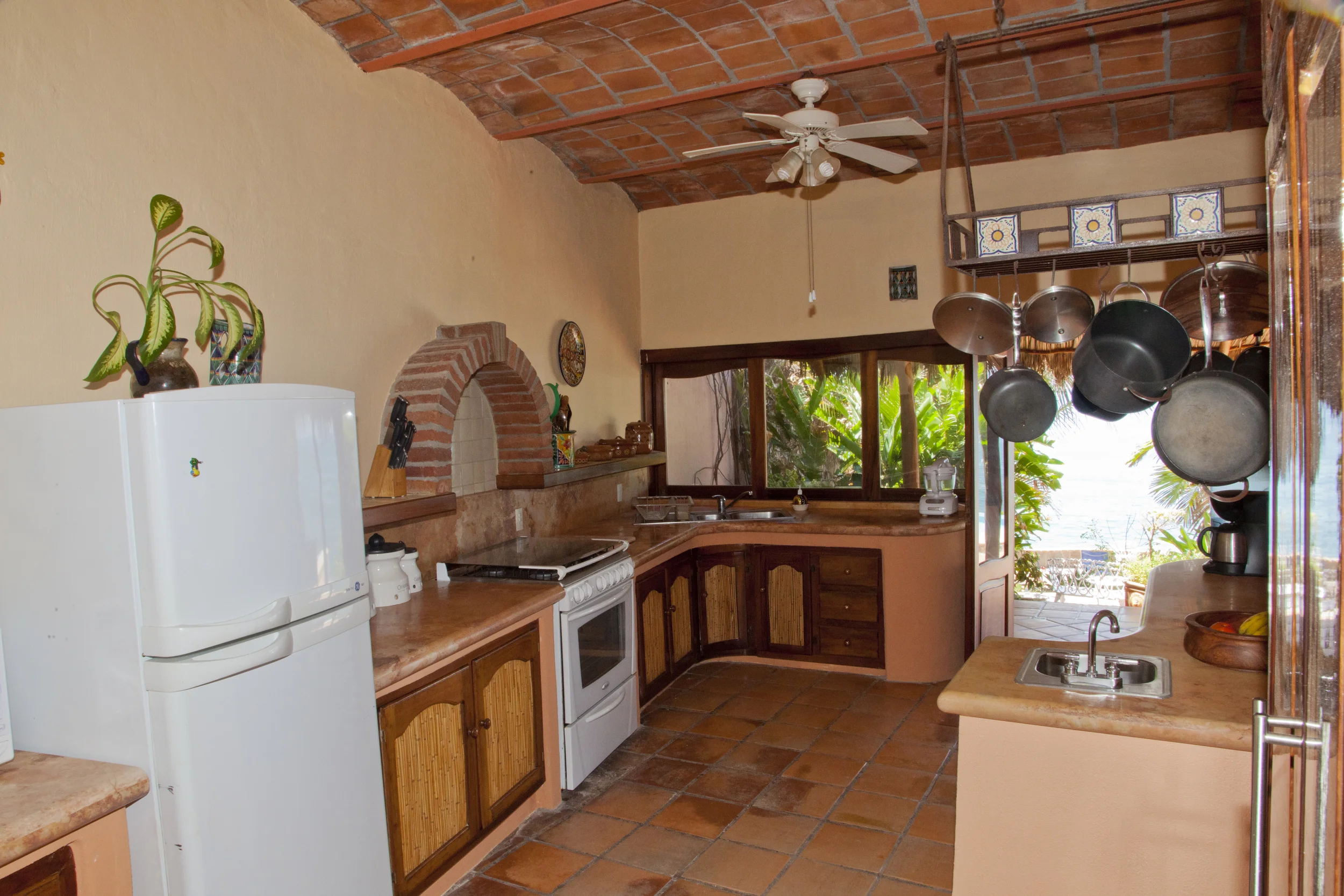 With granite counter tops, gas stove full size refrigerator, pass through windows and separate prep area with second sink, this kitchen can keep up with a family dinner or a full blown party.