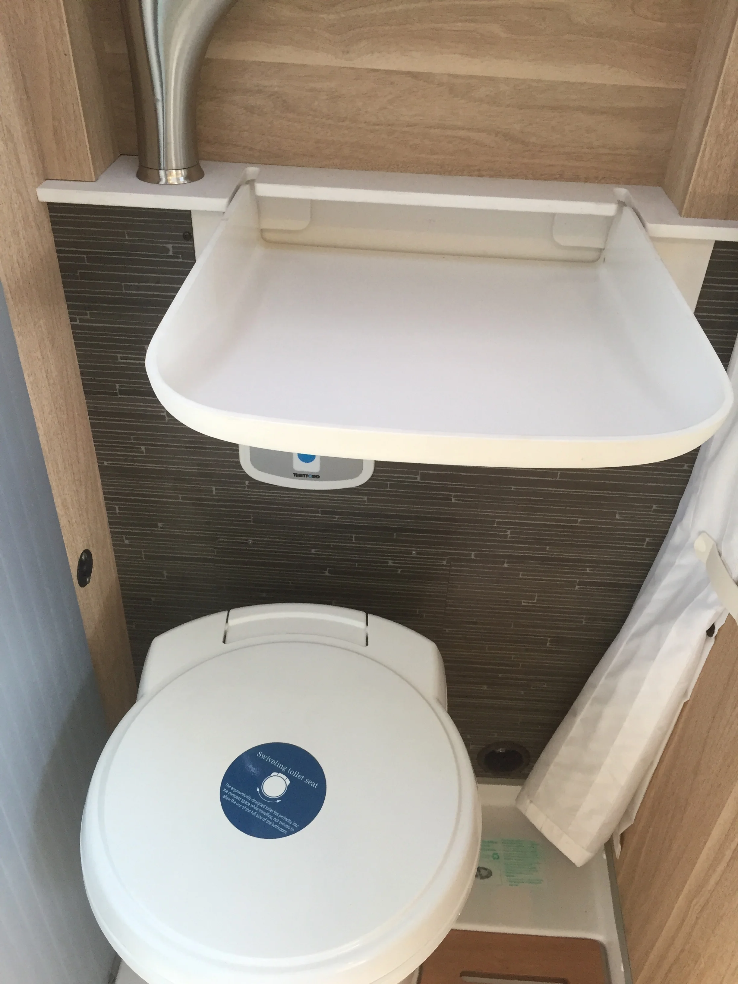 Fold-away sink in a tiny bathroom