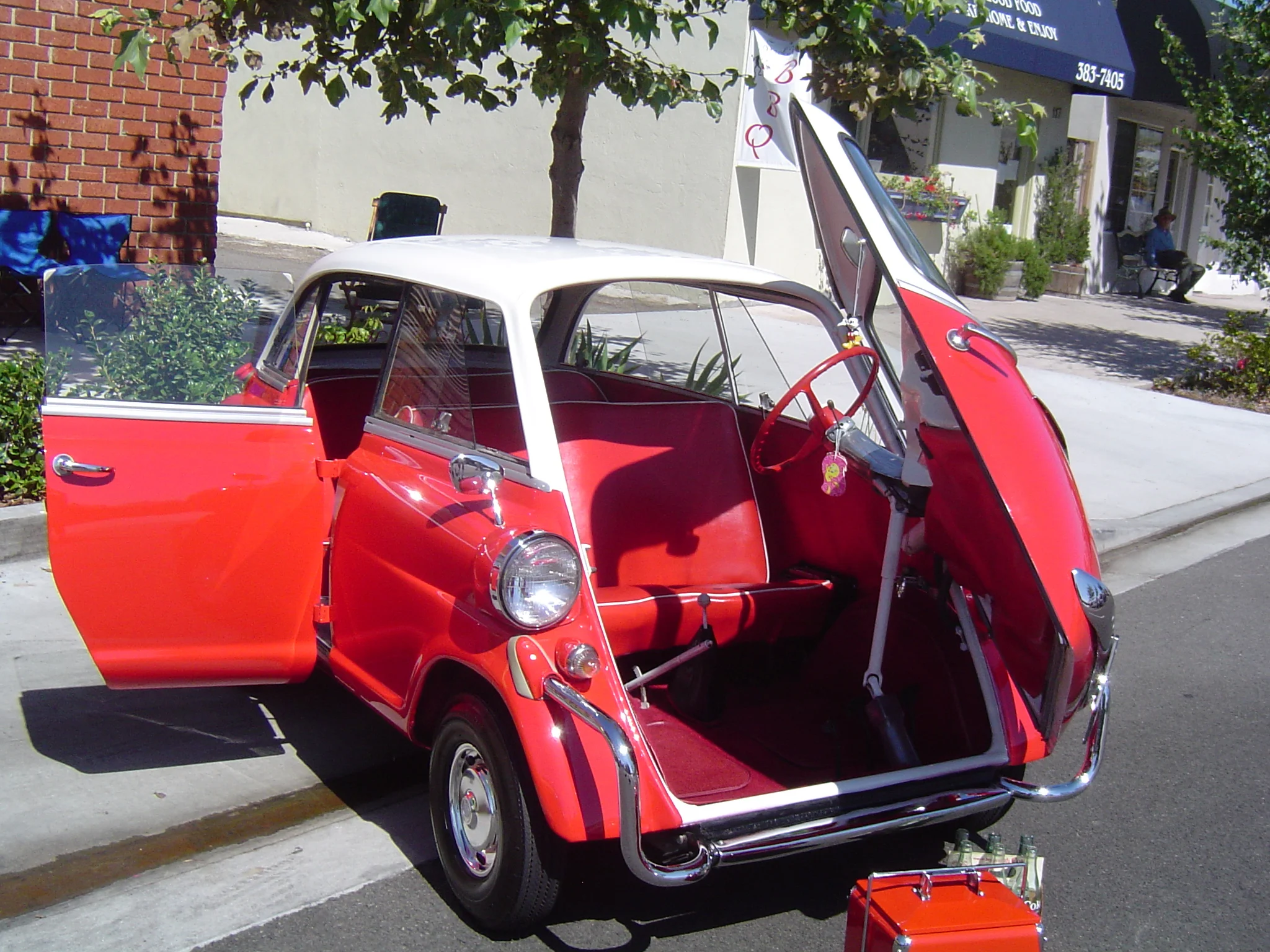 A later Isetta where the BMW added a rear seat to the car to increase its appeal as a family cruiser. Note the lack of a sunroof due to there being a single forward-hinged rear door.