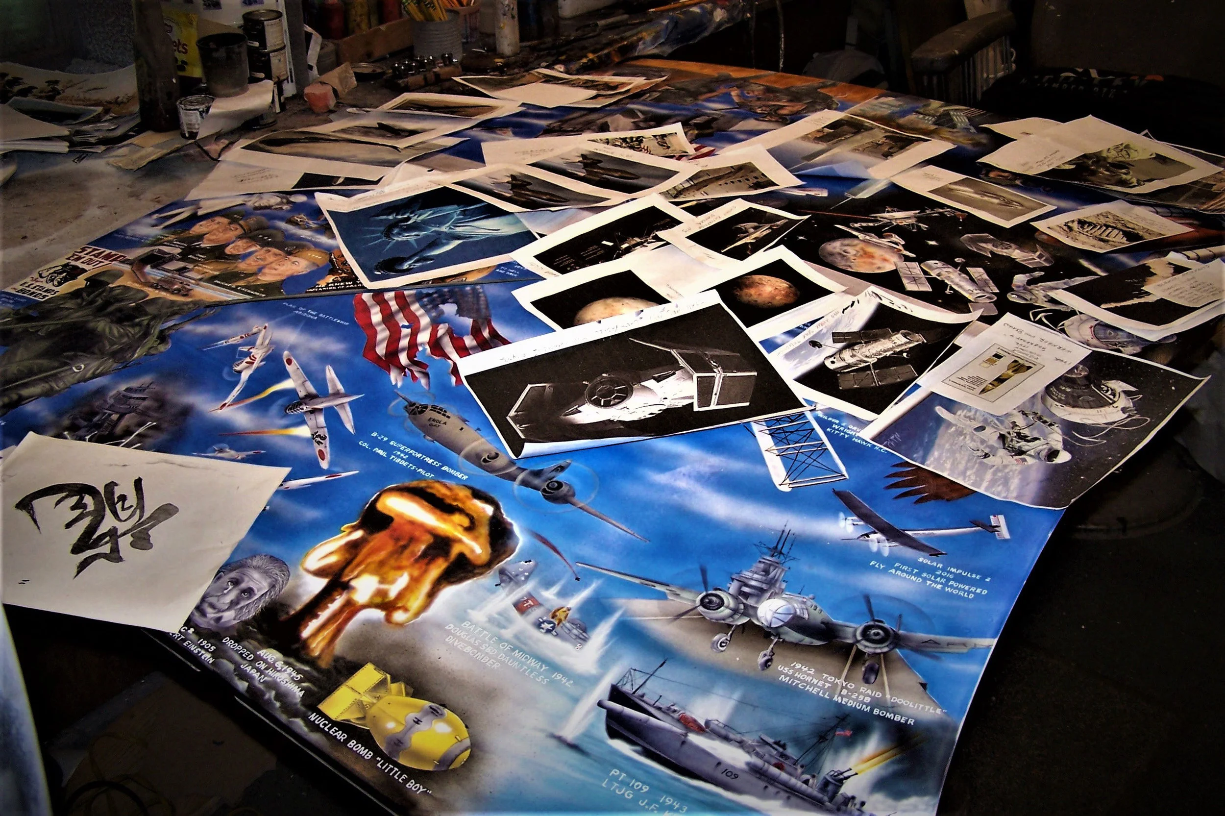A huge number of photos and research goes into each of the drawings on the El Camino. Here the hood is being worked on with stacks of photos for research.