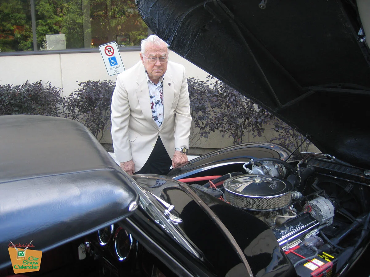 Phil Lacy looking at the engine compartment of the car he designed and helped build. Photo from 2007 TV show.