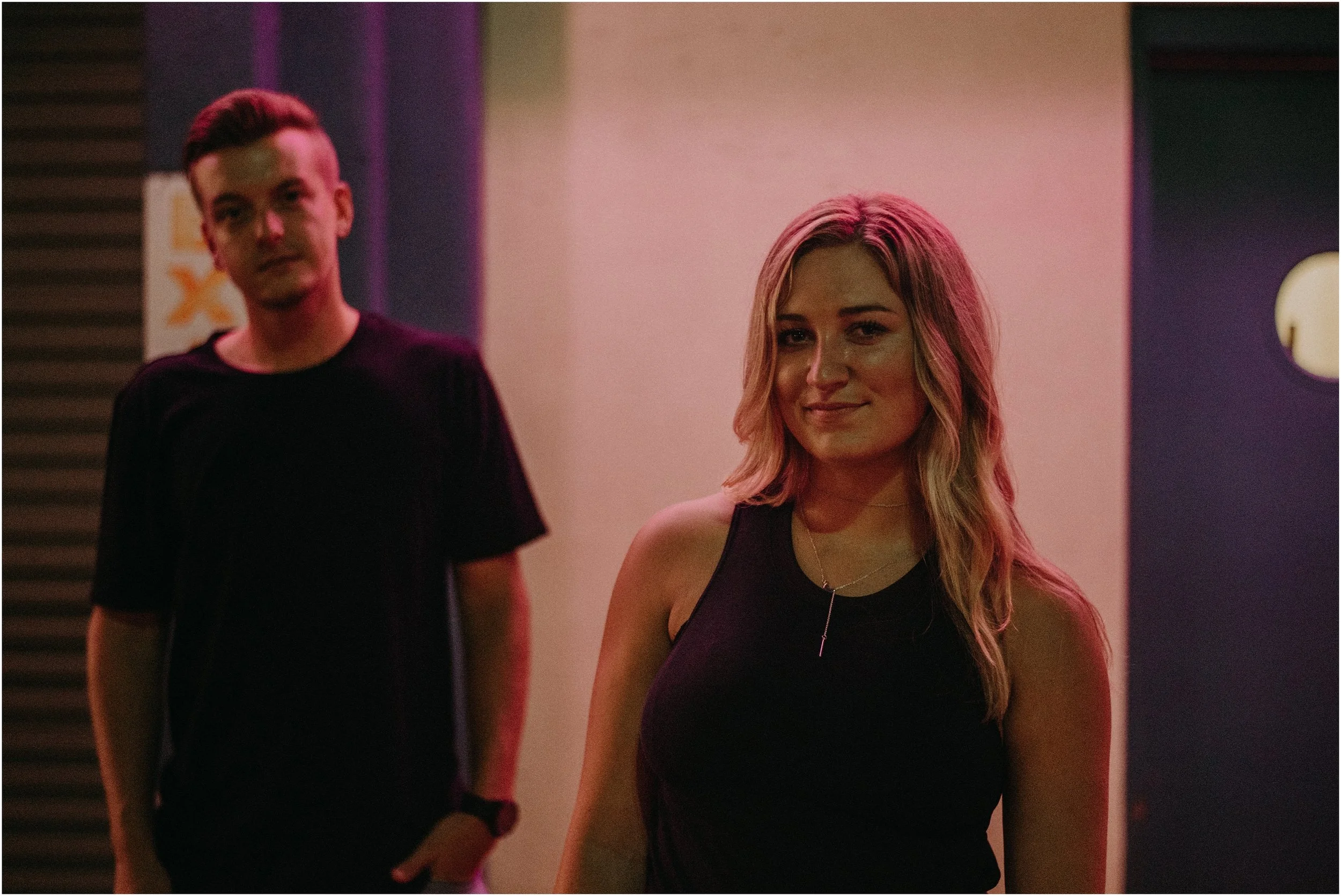 Hip couple has photo shoot at a car wash for neon lights at night