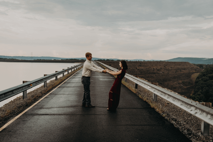 Bride and groom dance in the middle of the road