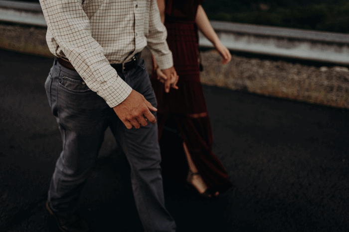 Couple walks hand in hand during their Raccoon Mountain engagement sesion