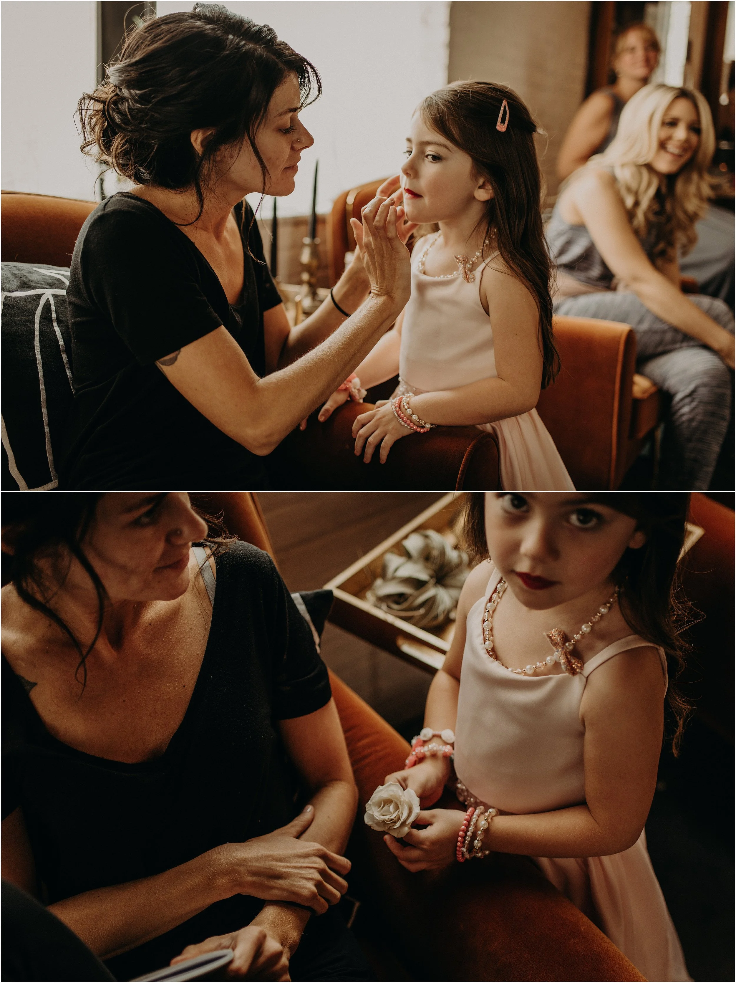 Mom applies lipstick on her daughter