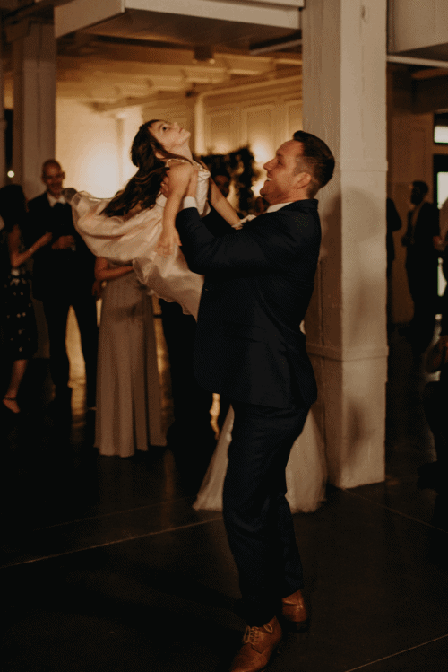 The groom spins his daughter on the dance floor