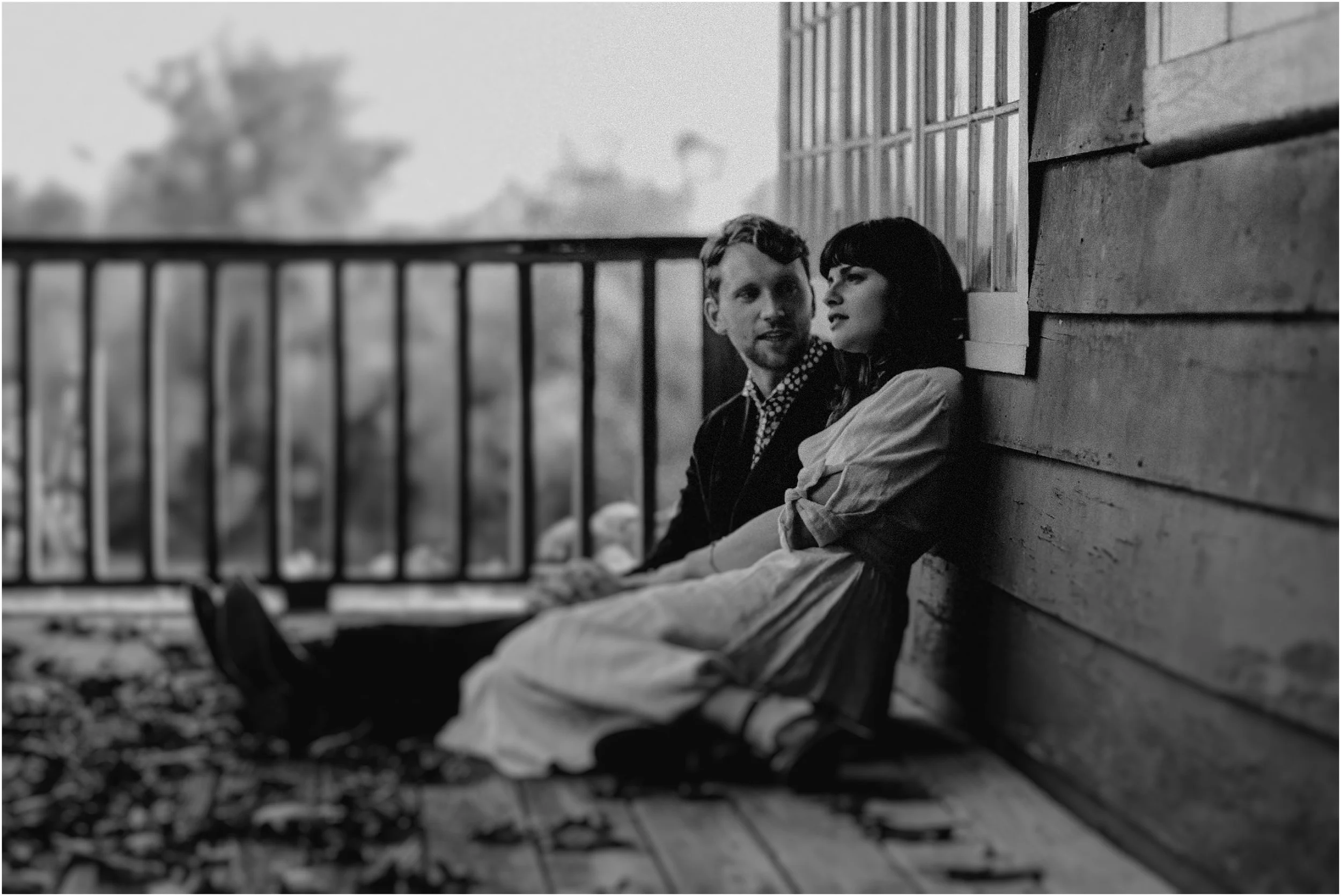 A reflective soft moment passes between the bride and groom
