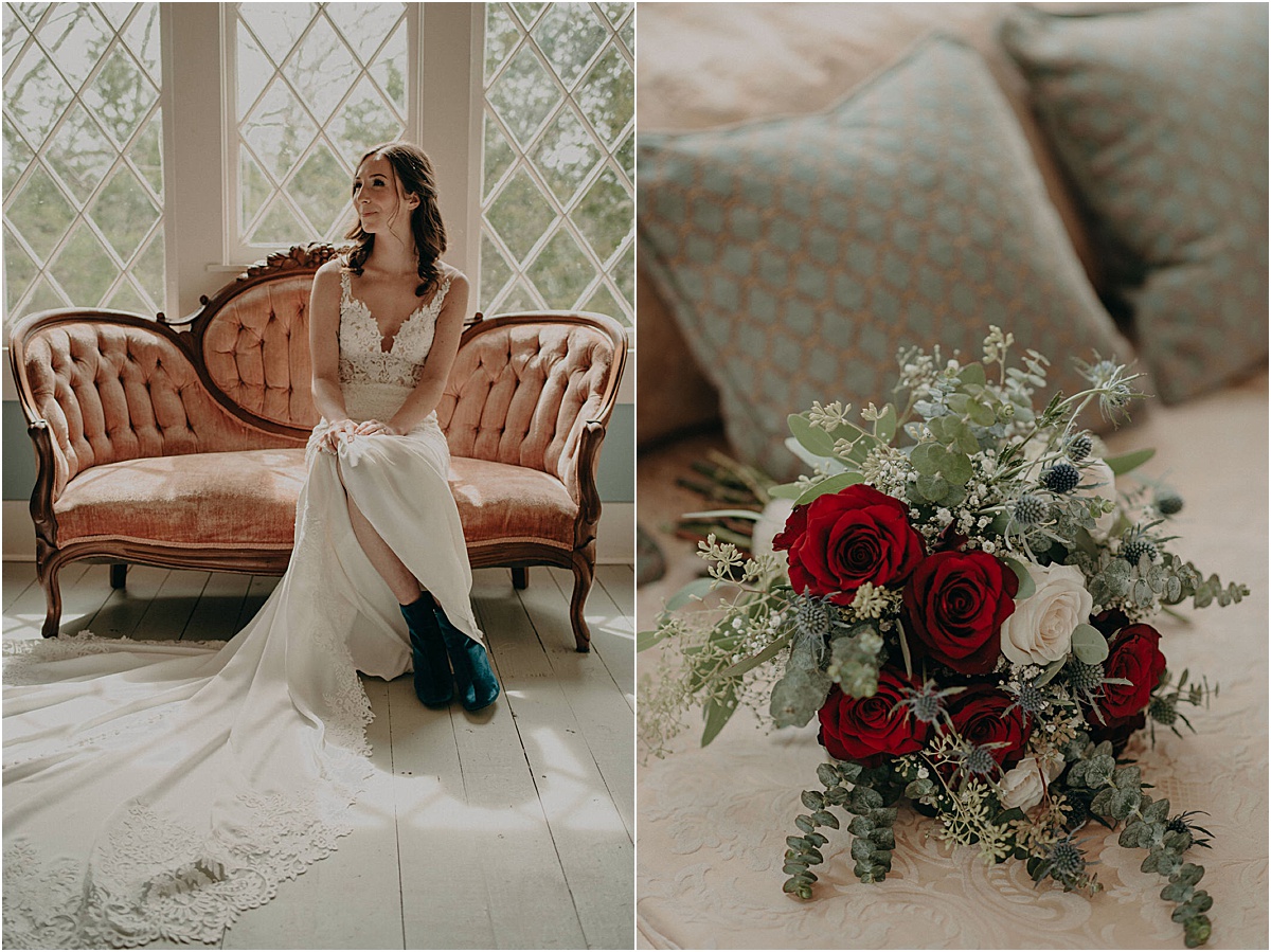 bride sitting on antique couch with bouquet of red and green flowers