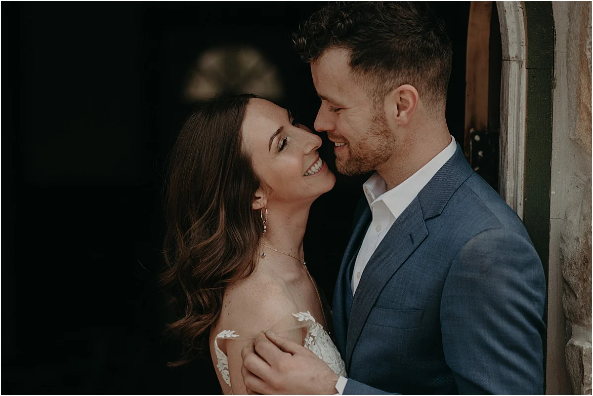 bride and groom smiling at each other before wedding ceremony