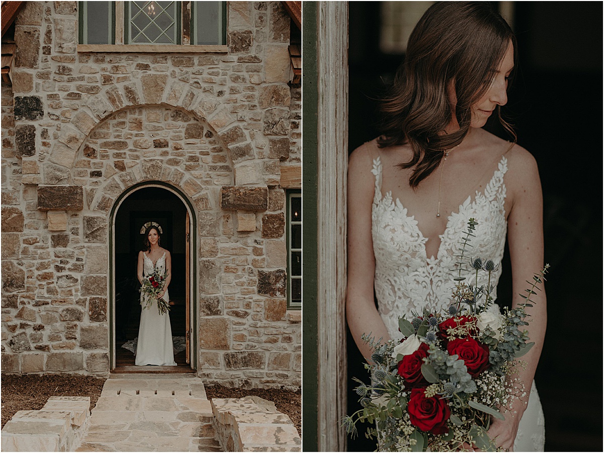 bride with red and green bouquet in front of brick cottage doorway