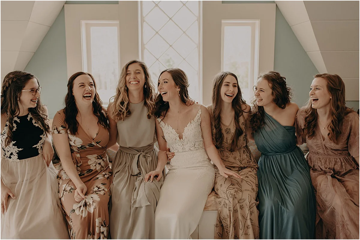 bridal party sitting laughing together