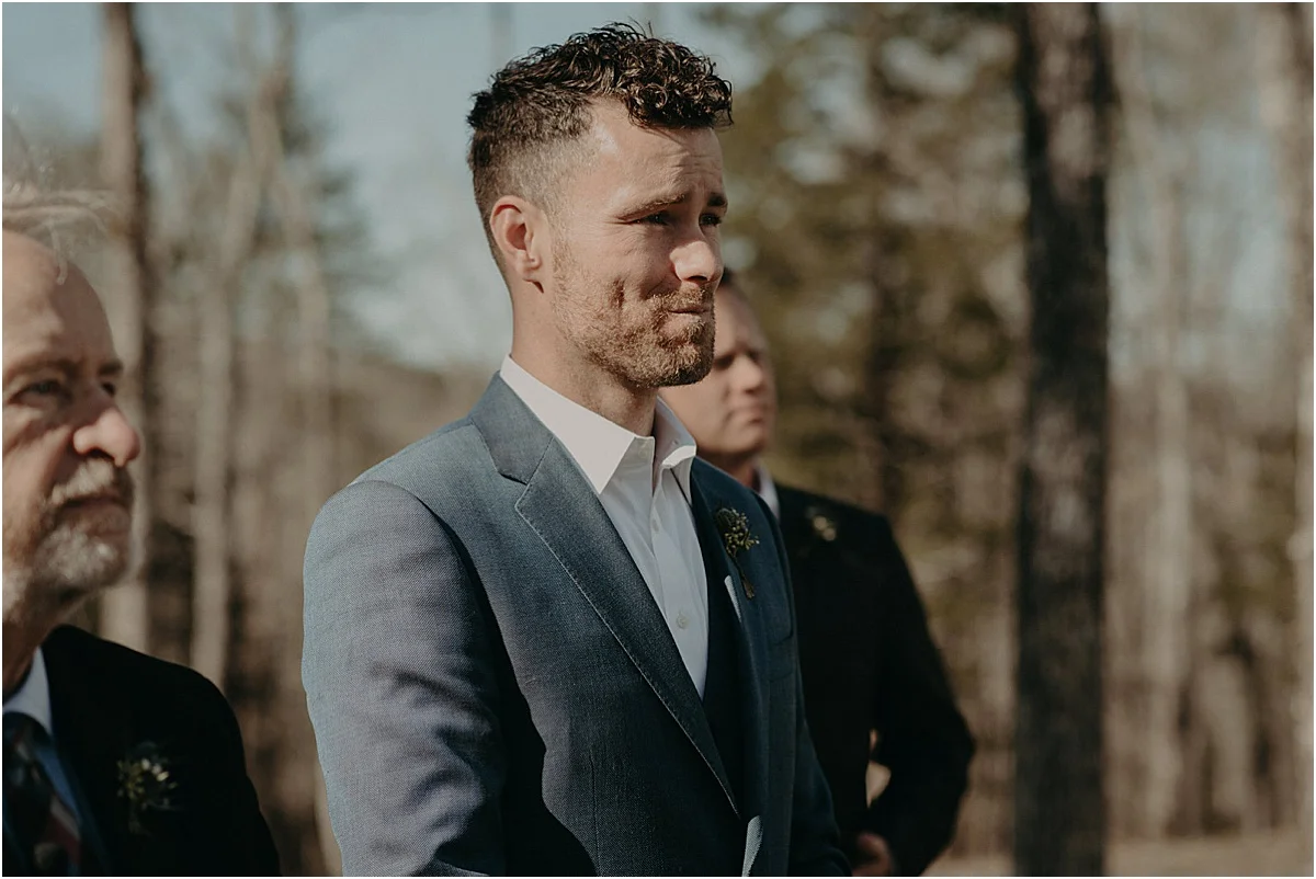 groom longing at bride walking down the aisle at wedding ceremony