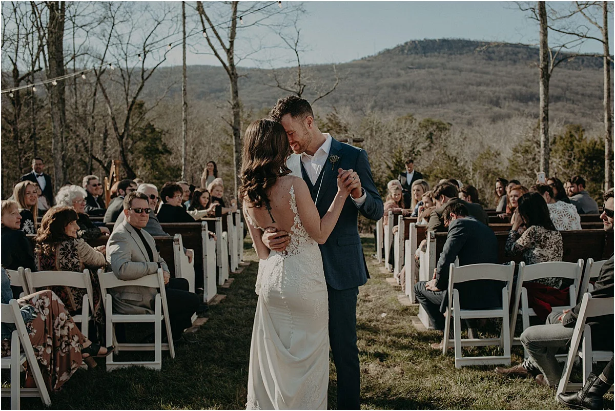 bride and groom dancing in middle of the aisle at wedding ceremony
