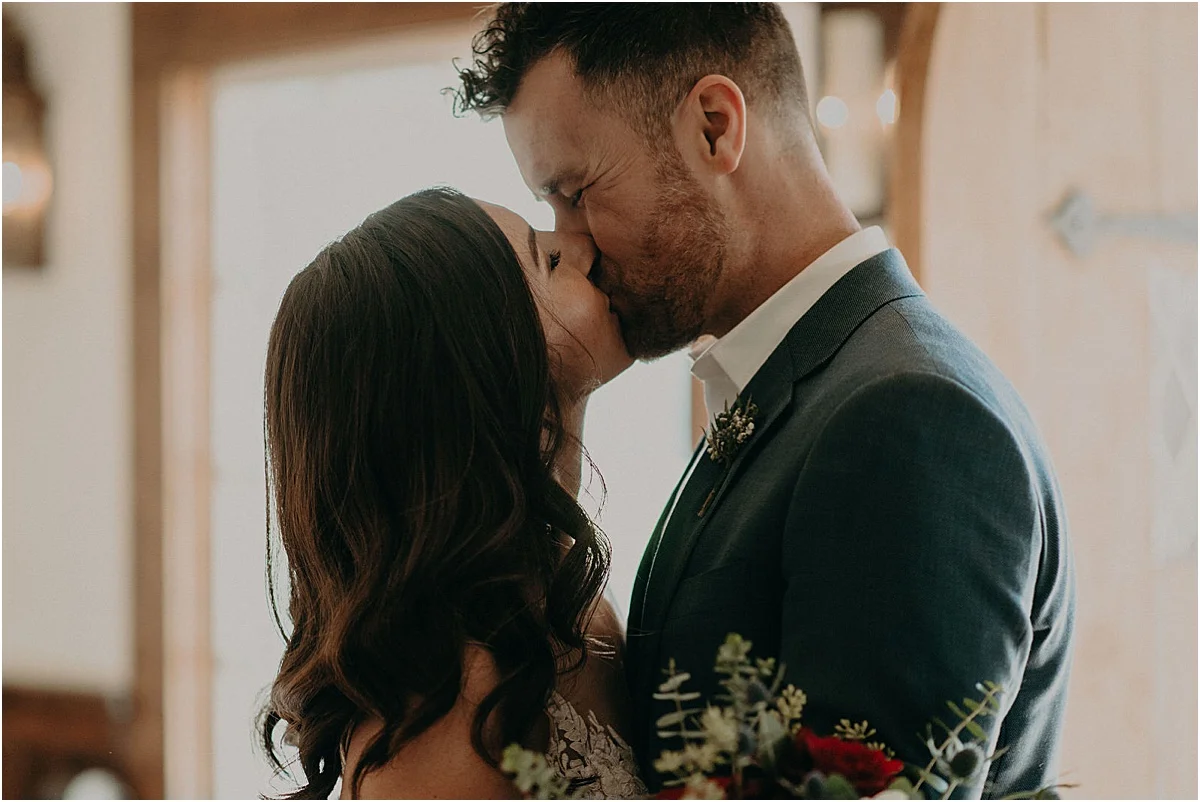 bride and groom kissing after candlelight ridge wedding ceremony