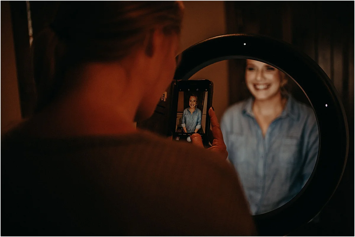 girl smiling for her picture on an iphone