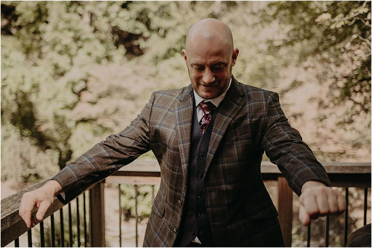 groom putting on plaid jacket